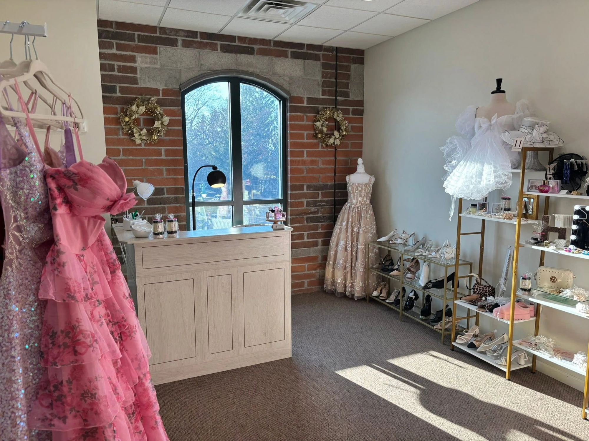 Inside Heather's Boutique in Oconomowoc, Wisconsin — prom and homecoming dresses, shoes, and accessories displayed against an exposed brick wall