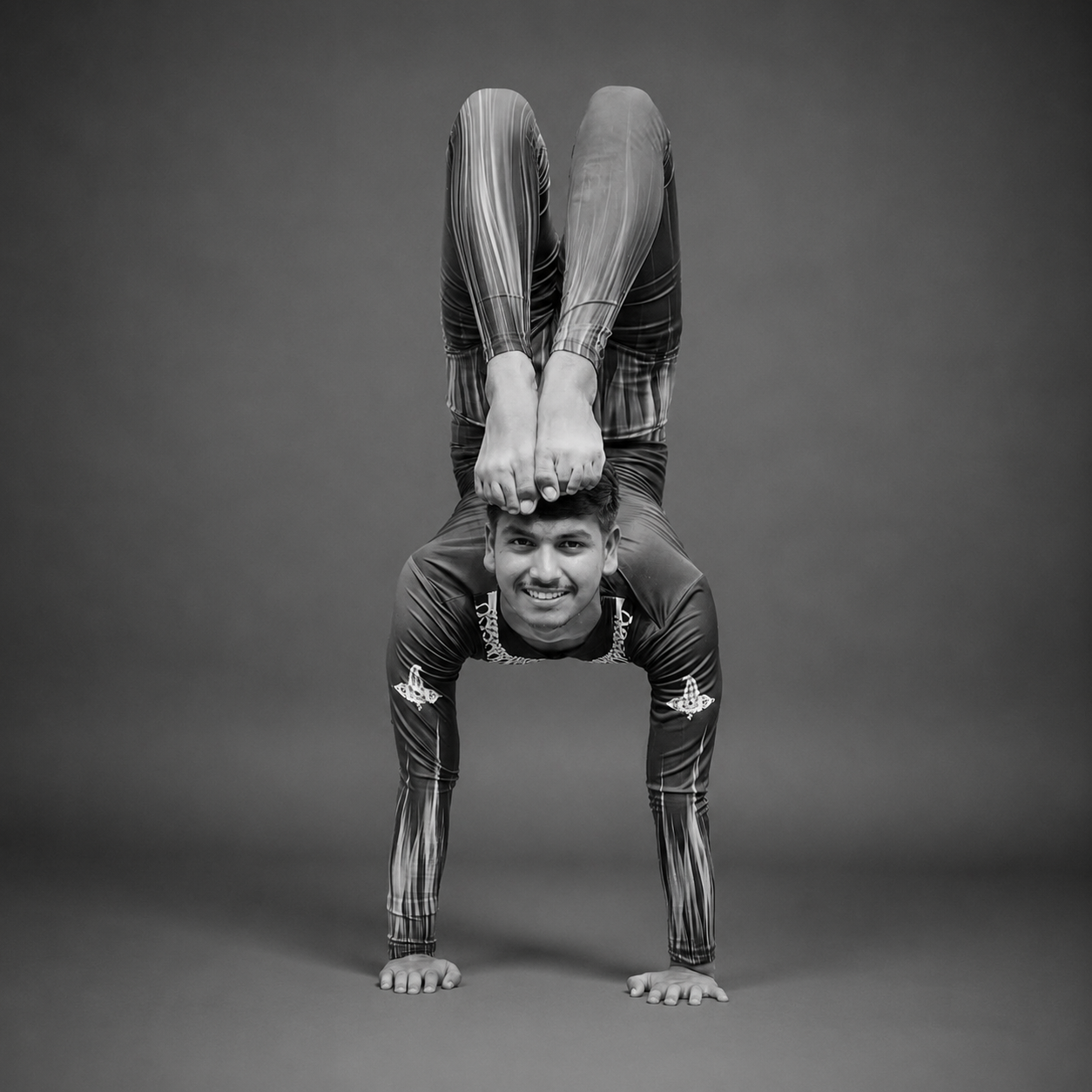 Trainer Aryan performing an advanced yogasana arm balance