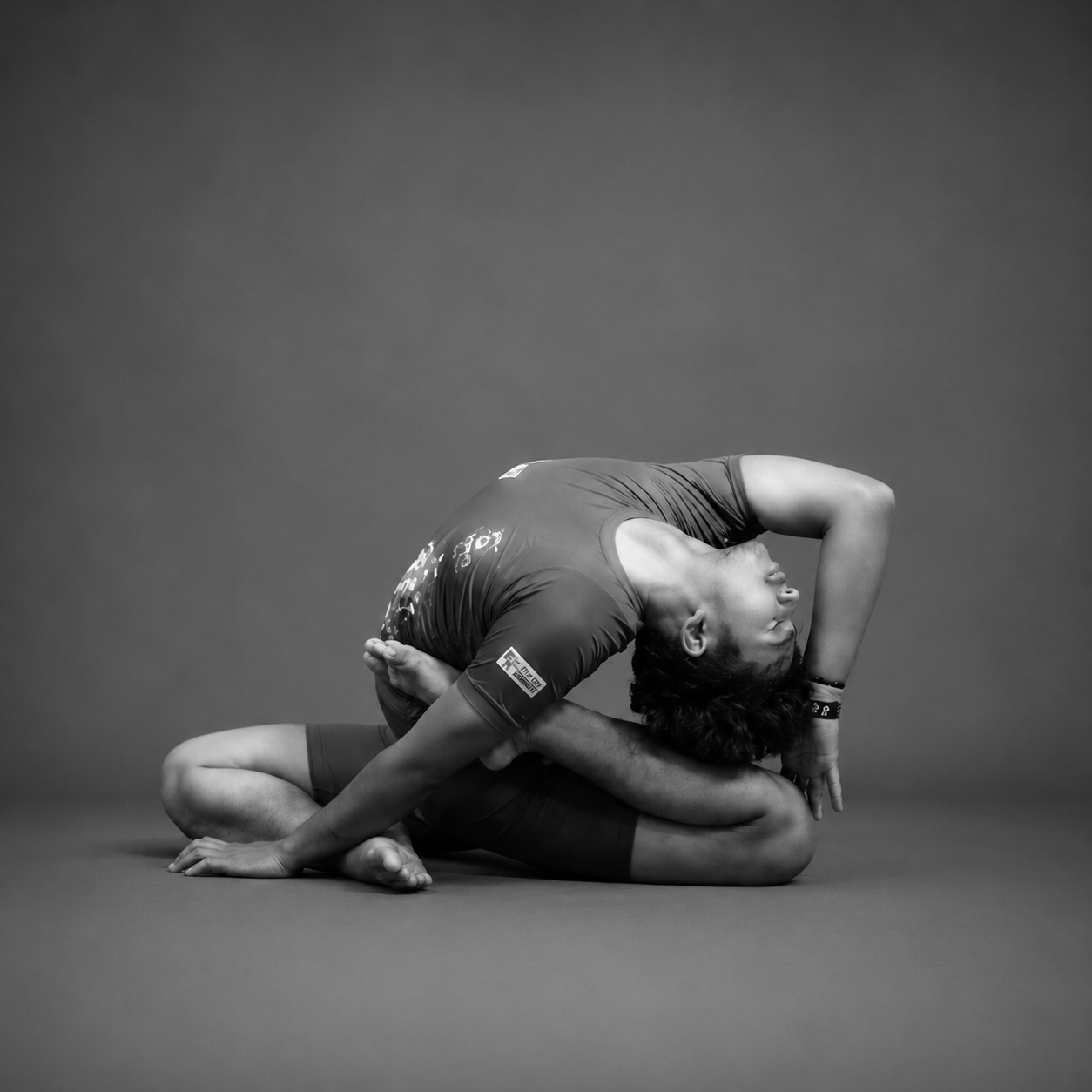 Trainer Aryan in an advanced seated backbend asana