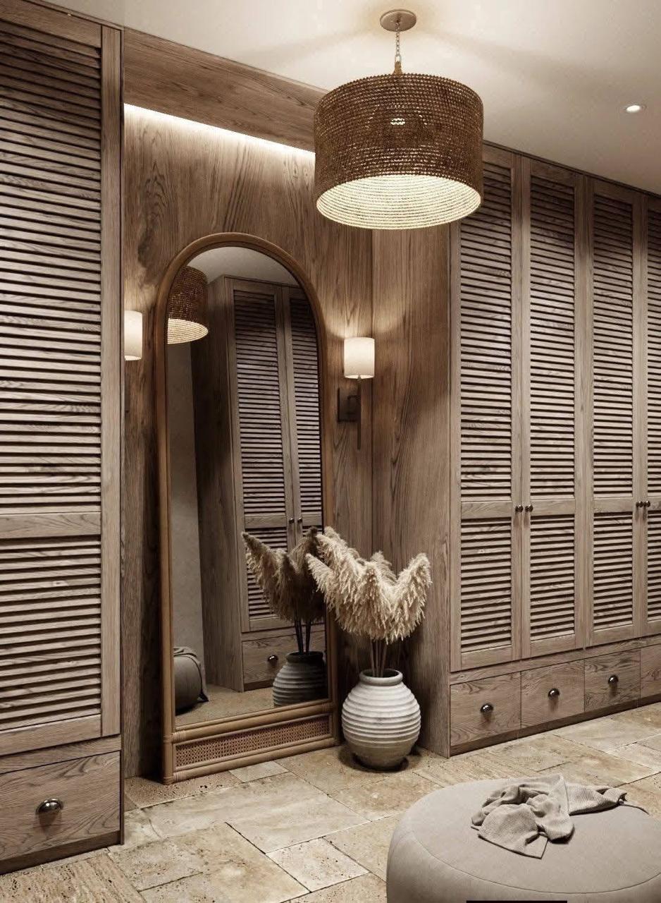Bespoke walnut walk-in wardrobe with arched mirror and pendant light by Innovation Modular System
